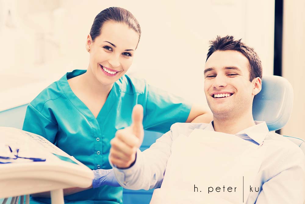 Man giving thumbs up at dentist office