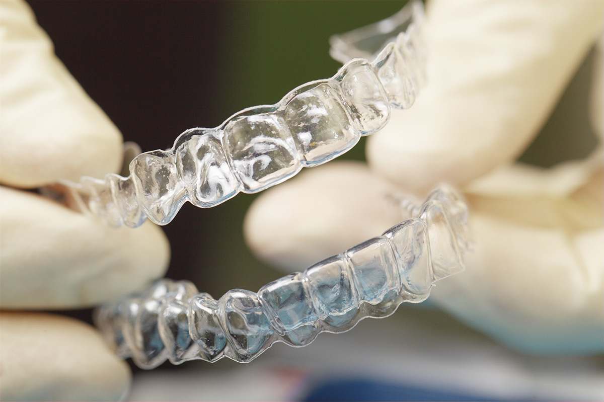 Doctors hands holding silicone mouth guard