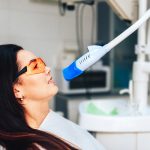 Teeth whitening in dental clinic for female patient
